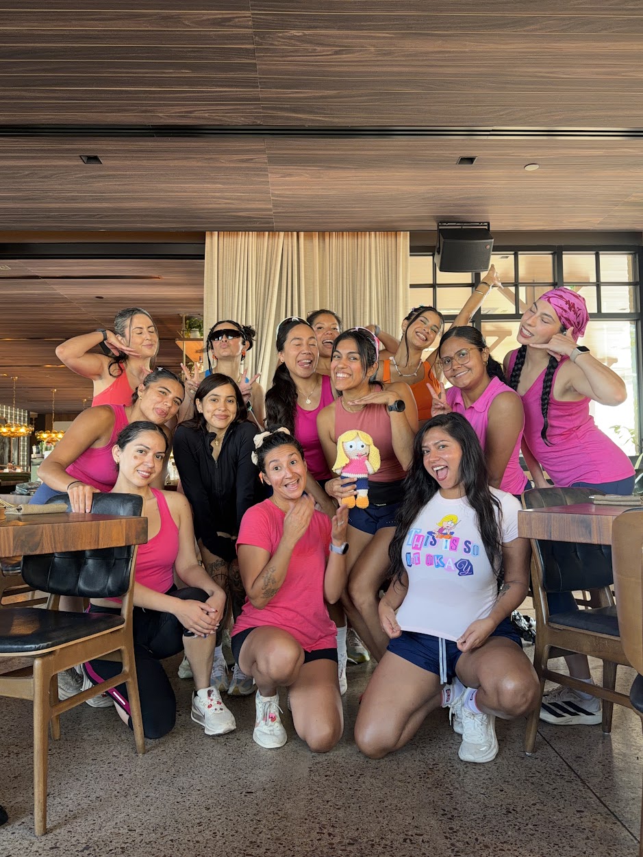 The Hot Girls Run AZ crew posing together after a run, most of them in pink